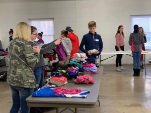 The Caring Center Volunteers Sorts Out Donated Clothes.